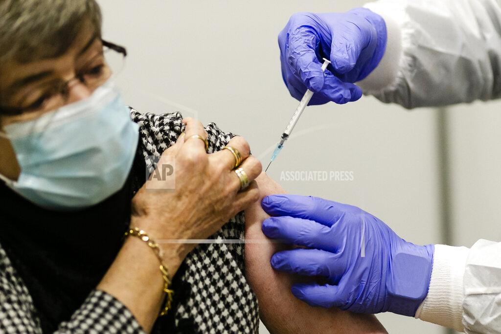Frank Molter 81-year-old Ursula Claassen receives a new coronavirus vaccination in Kiel, Germany, Monday, Jan. 4, 2021. On Monday vaccinations against the coronavirus have started in the German state of Schleswig-Holstein. (Frank Molter/dpa via AP)