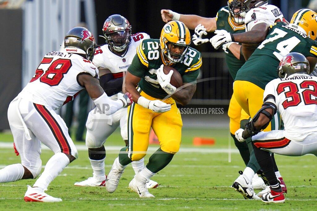 Chris O'meara Green Bay Packers' AJ Dillon runs during the second half of an NFL football game against the Tampa Bay Buccaneers Sunday, Sept. 25, 2022, in Tampa, Fla. (AP Photo/Chris O'Meara)