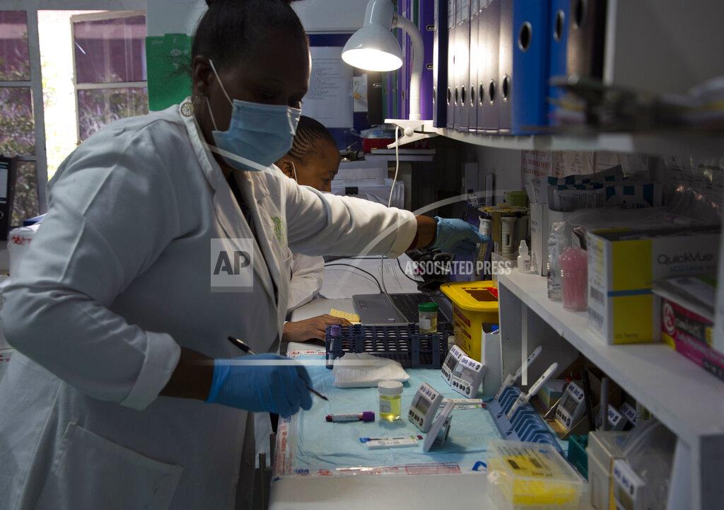 Denis Farrell Laboratory technicians test a blood sample for HIV infection at the Reproductive Health and HIV Institute (RHI) in Johannesburg, Thursday, Nov. 26 2020. The successful trials of a new injectable drug that needs to be taken every eight weeks to prevent HIV infection is being lauded on World AIDS Day as a turning point for the fight against a global health threat that's been eclipsed by the coronavirus pandemic. (AP Photo/Denis Farrell)
