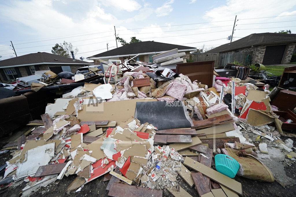 Gerald Herbert Debris piles up at curbside as residents gut their flooded homes in the aftermath of Hurricane Ida in LaPlace, La., Tuesday, Sept. 7, 2021. (AP Photo/Gerald Herbert)