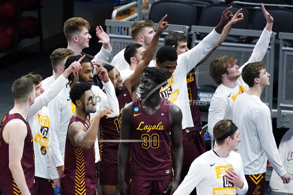 Mark Humphrey Loyola of Chicago players celebrate after beating Illinois in a college basketball game in the second round of the NCAA tournament at Bankers Life Fieldhouse in Indianapolis Sunday, March 21, 2021. Loyola upset Illinois 71-58. (AP Photo/Mark Humphrey)