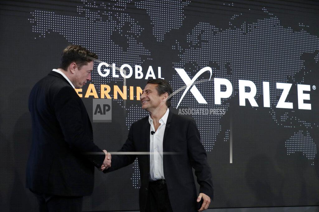 Marcio Jose Sanchez FILE - Tesla CEO Elon Musk, left, shakes hands with XPRIZE founder and Executive Chairman Peter Diamandis during the presentation of the XPRIZE for Children's Literacy in Los Angeles, in this Wednesday, May 15, 2019, file photo. Organizers of a $20 million contest to develop products from greenhouse gas that flows from power plants announced two winners Monday, April 19, 2021, ahead of launching a similar but much bigger competition backed by Elon Musk. Both winners made concrete that trapped carbon dioxide, keeping it out of the atmosphere, where it can contribute to climate change. Production of cement, concrete's key ingredient, accounts for 7% of global emissions of the greenhouse gas, said Marcius Extavour, XPRIZE vice president of climate and energy.(AP Photo/Marcio Jose Sanchez, File)