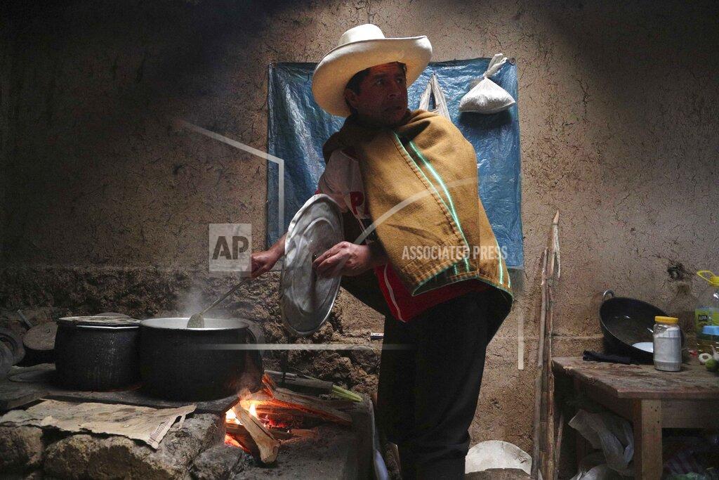 Martin Mejia Free Peru party presidential candidate Pedro Castillo cooks breakfast for his family in his home in Chugur, Peru, Friday, April 16, 2021. Castillo, a rural teacher, who has proposed rewriting Peru's constitution and deporting all immigrants living in the country illegally who commit crimes, will face rival candidate Keiko Fujimori in the June 6 presidential run-off election. (AP Photo/Martin Mejia)