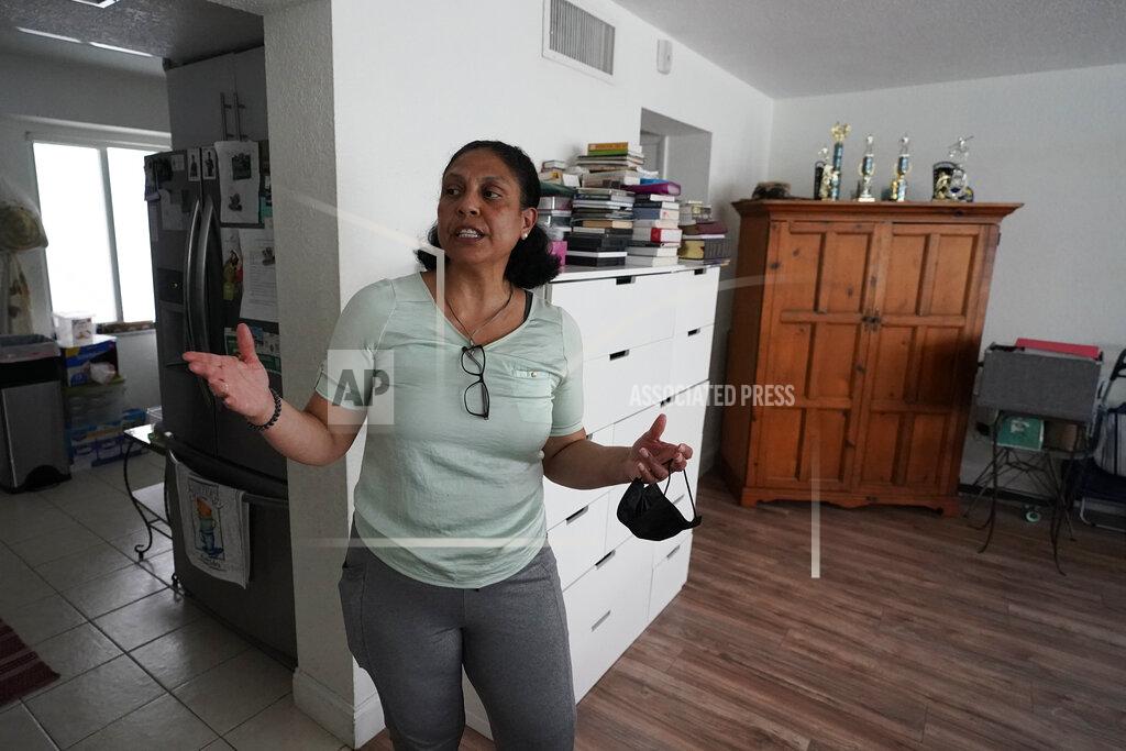Wilfredo Lee Cristina Livingston recounts the problems she has had in her apartment including a leaking ceiling and mold, Friday, June 18, 2021, at her home in Bay Harbor Islands, Fla. The Biden administration on Thursday, June 24, extended the nationwide ban on evictions for a month to help millions of tenants unable to make rent payments during the coronavirus pandemic but said this is expected to be the last time it does so. Livingston, mother of two had lost her administrative assistant job during the pandemic, said she was relieved to hear it had been extended. (AP Photo/Wilfredo Lee)