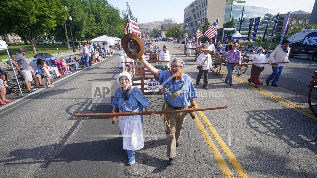 Rick Bowmer People pull handcarts during the Pioneer Day Parade Friday, July 23, 2021, in Salt Lake City. People in Utah are gathering to celebrate the state's history and recognize early Mormon pioneers who trekked West in search of religious freedom. Pioneer Day is a beloved only-in-Utah holiday every July 24 that features parades, rodeos, fireworks and more. The festivities were canceled last year because of the pandemic.(AP Photo/Rick Bowmer)
