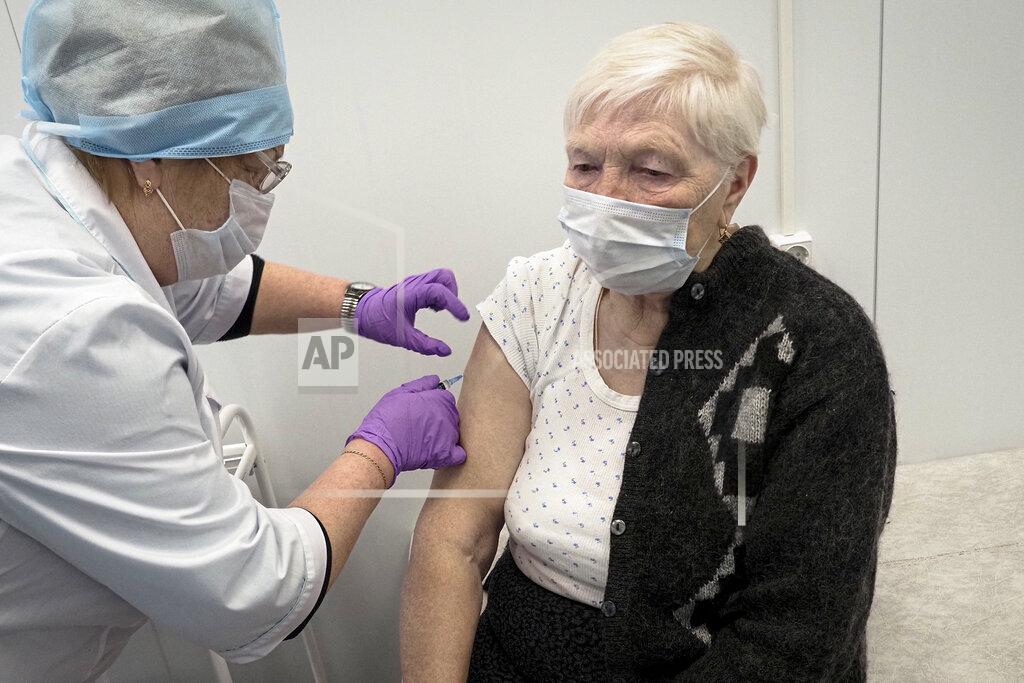 Dmitri Lovetsky A Russian medical worker administers a shot of Russia's Sputnik V coronavirus vaccine to Galina Shilova in a local rural medical post in the village of Ikhala in Russia’s Karelia region, Tuesday, Feb. 16, 2021. “When you watch TV and see how people are suffering … you don’t want that. You want to live a little longer,” Shilova said. (AP Photo/Dmitri Lovetsky)