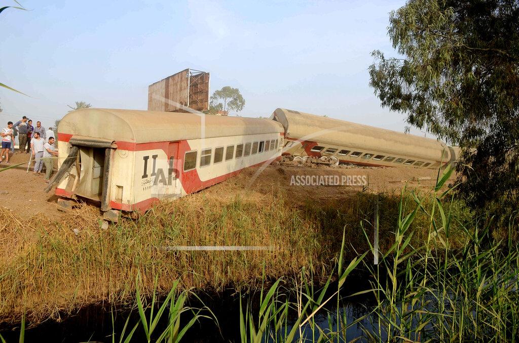 Tarek Wagih People gather at the site where a passenger train derailed injuring at least 100 people, near Banha, Qalyubia province, Egypt, Sunday, April 18, 2021. At least eight train wagons ran off the railway, the provincial governor's office said in a statement. (AP Photo/Tarek Wagih)