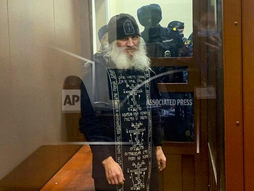FILE - In this handout photo released by Basmanny Court via Moscow News Agency, Father Sergiy, a Russian monk who has defied the Russian Orthodox Church's leadership, stands in a cage prior to a court session in Moscow, Russia, Dec. 29, 2020. Father Sergiy, who castigated the Kremlin and denied the coronavirus existence was convicted Tuesday, Nov. 30, 2021 on accusations of encouraging suicides and handed a 3 1/2-year prison sentence. (Basmanny Court, Moscow News Agency photo via AP, File)