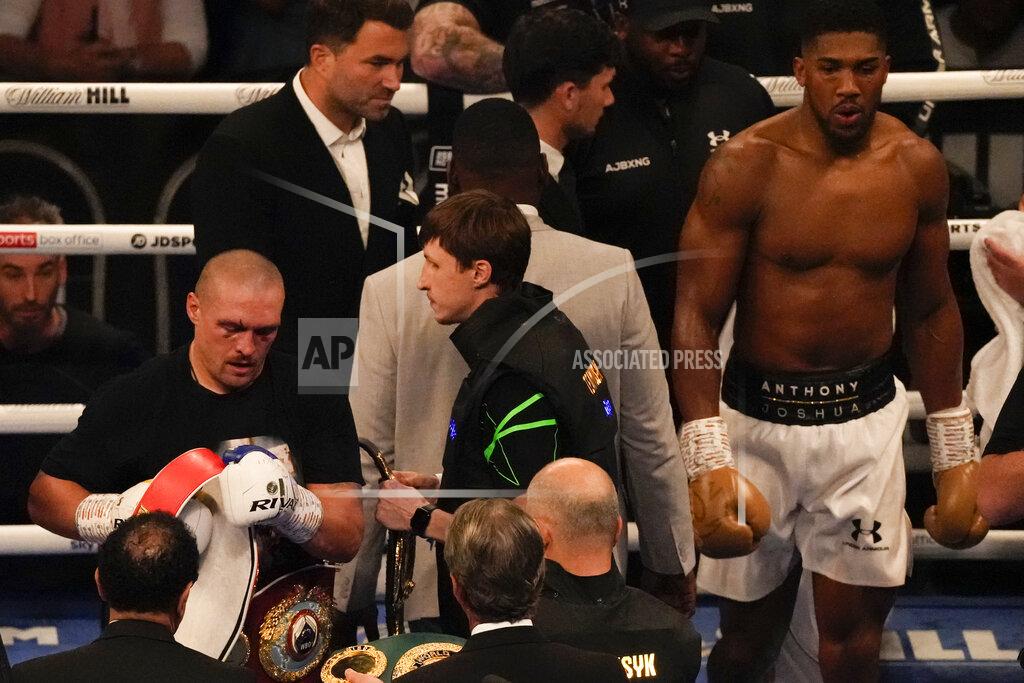 Frank Augstein Oleksandr Usyk of Ukraine examines his winner's belts after his unanimous decision over Anthony Joshua of Britain in their WBA (Super), WBO and IBF boxing title bout at the Tottenham Hotspur Stadium in London, Saturday, Sept. 25, 2021. (AP Photo/Frank Augstein)