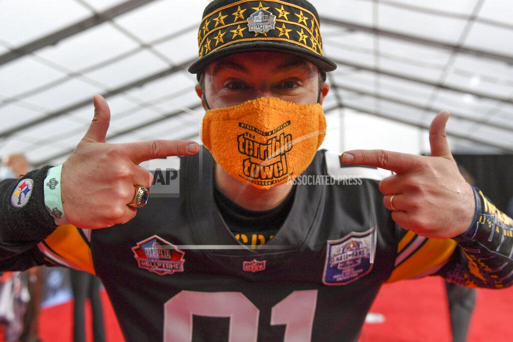 David Dermer CORRECTS NAME OF PERSON TO RICK HOLMAN, INSTEAD OF DAVID DERMER- Rick Holman, a fan of the Pittsburgh Steelers, points out his "Terrible Mask" as he waits for potential draftees to appear on the fed carpet at the Rock & Roll Hall of Fame before the NFL football draft, Thursday, April 29, 2021, in Cleveland. (AP Photo/David Dermer, Pool)