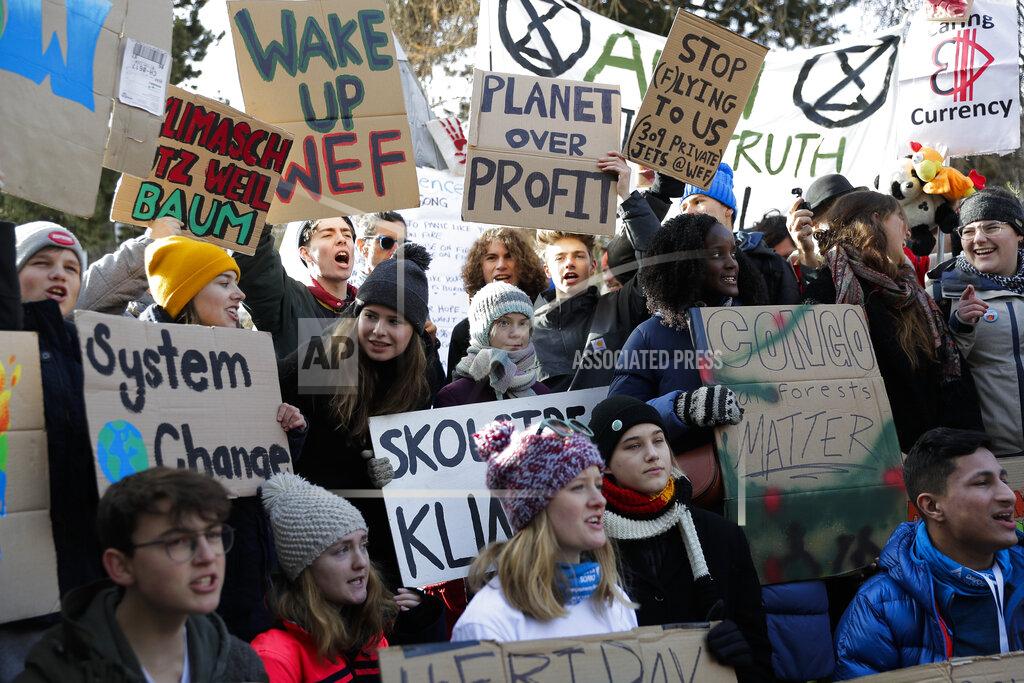 Markus Schreiber FILE - Swedish climate activist Greta Thunberg, centre with blue gray striped hat, attends a Friday for Future protest in Davos, Switzerland, Friday, Jan. 24, 2020. After a nearly 2-1/2-year hiatus, the Swiss town of Davos is set to again host global elites from business, government and activist groups for the World Economic Forum. Russia’s war in Ukraine and climate change worries are expected to be on many minds at the event starting Monday, May 23, 2022 as concern over the pandemic ebbs. (AP Photo/Markus Schreiber, file)