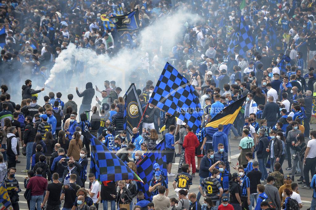 Claudio Furlan Inter Milan fans celebrate and shout slogans in Piazza Duomo square in front of the gothic cathedral after Inter Milan won its first Serie A title in more than a decade after second-placed Atalanta drew 1-1 at Sassuolo, in Milan, Italy, Sunday, May 2, 2021. Atalanta needed to win to avoid Inter mathematically clinching the title with four matches remaining. It was Inter’s first trophy since 2011 and the first Serie A title since 2010. (Claudio Furlan/LaPresse via AP)