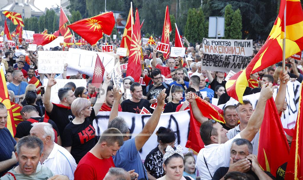 Boris Grdanoski People hold banners and wave the old and current national flags during a protest in front of the government building in Skopje, North Macedonia, on Saturday, July 2, 2022. Tens of thousands of people gathered late Saturday outside government offices in North Macedonia’s capital to protest the latest proposal on solving a dispute with Bulgaria in order for North Macedonia to open membership talks with the European Union. (AP Photo/Boris Grdanoski)
