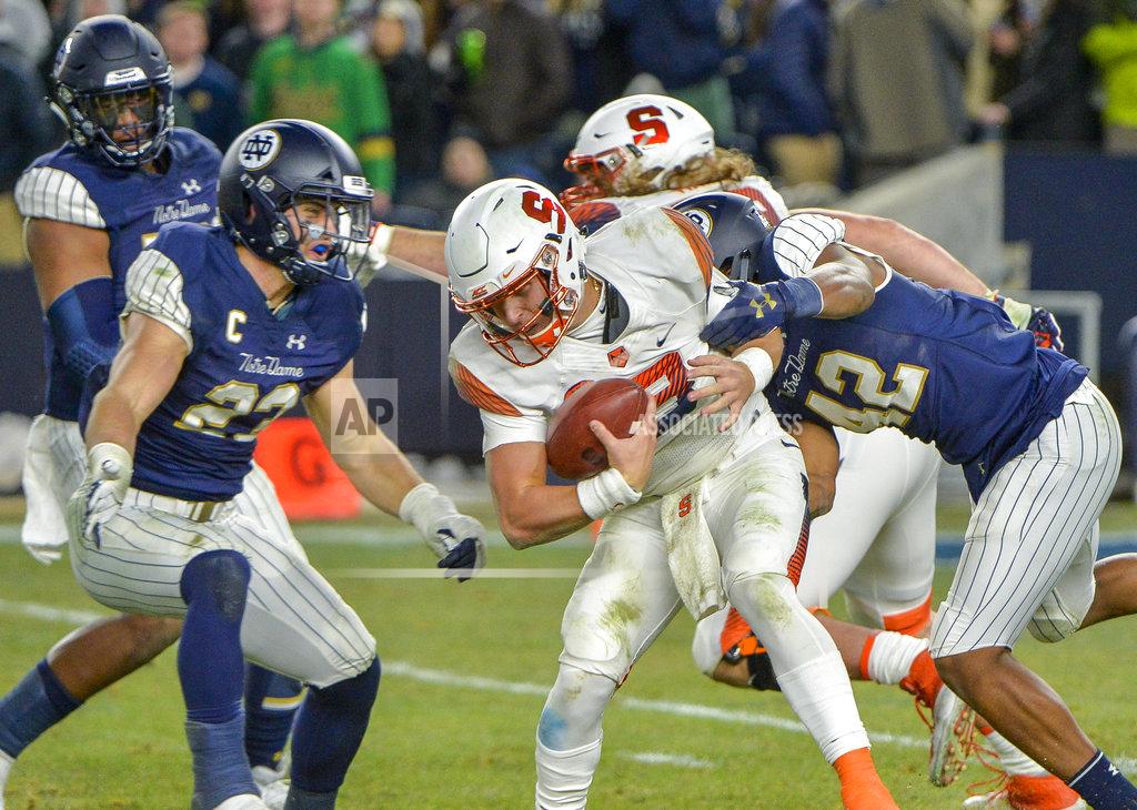 Howard Simmons Syracuse quarterback Tommy DeVito (13) is sacked by the Notre Dame defense during an NCAA college football game, Saturday, Nov. 17, 2018, at Yankee Stadium in New York. (AP Photo/Howard Simmons)