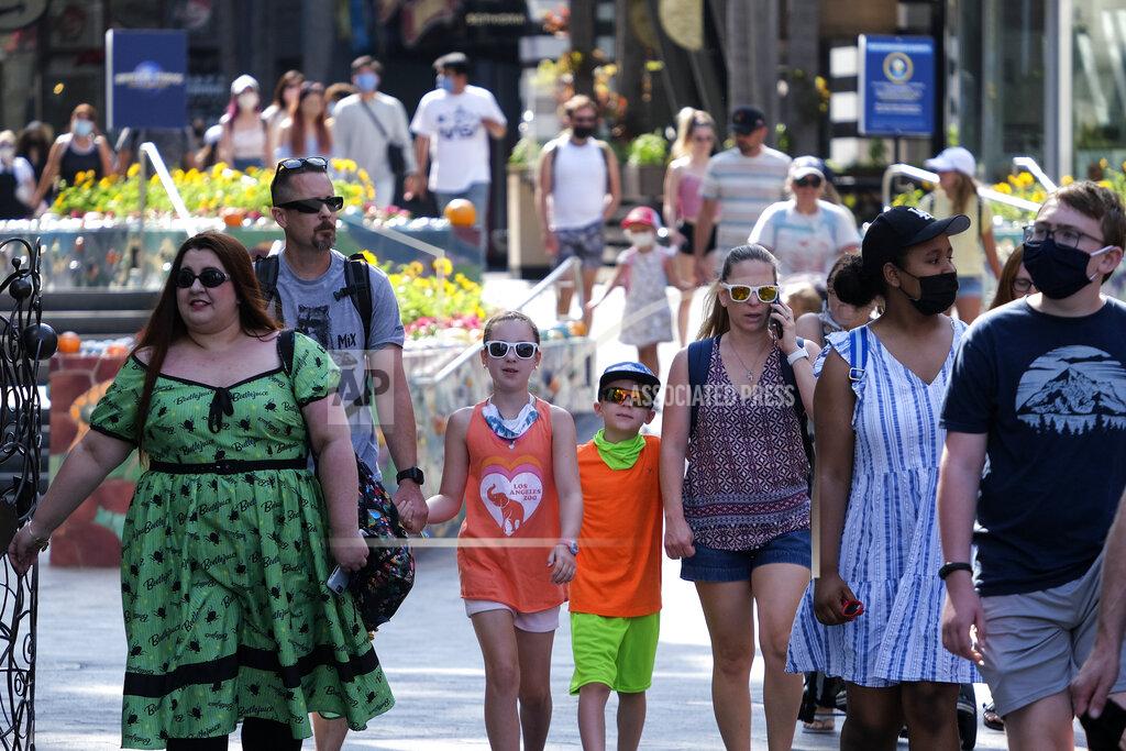 Ringo H.w. Chiu People arrive at Universal Studios in Universal City, Calif., Tuesday, June 15, 2021. On Tuesday, California lifted most of its COVID-19 restrictions and ushered in what has been billed as the state’s “Grand Reopening.” (AP Photo/Ringo H.W. Chiu)