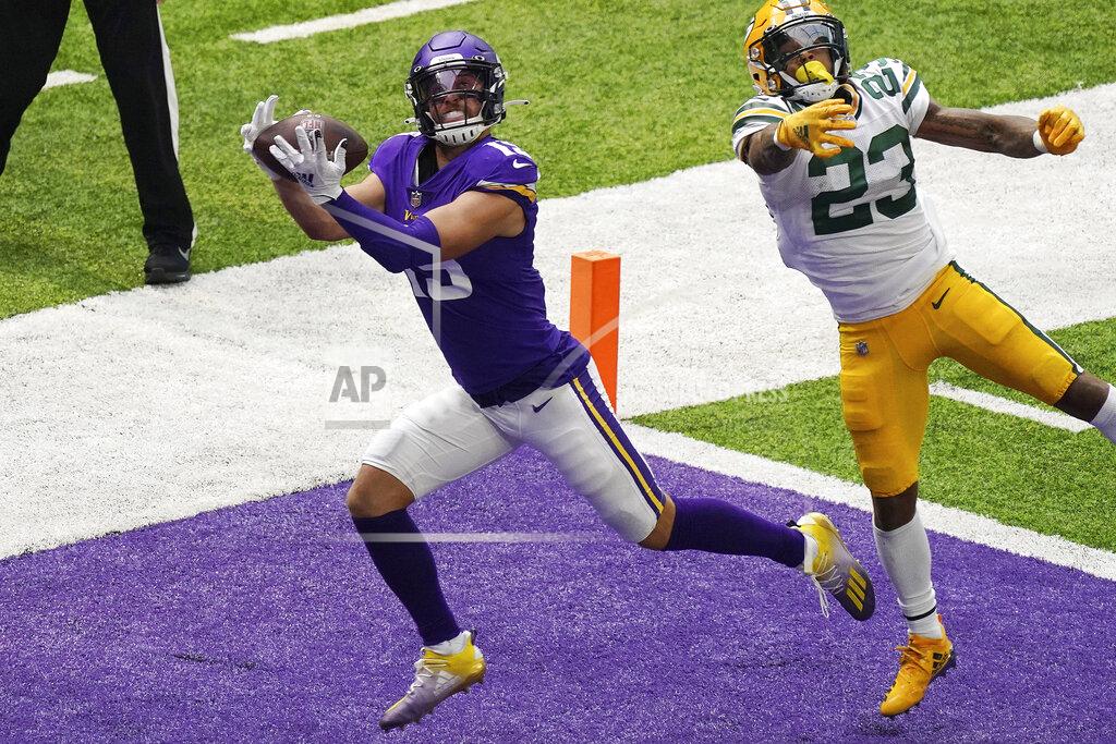 Minnesota Vikings wide receiver Adam Thielen (19) hauled in a touchdown pass as Green Bay Packers cornerback Jaire Alexander (23) tries to defend in the second half of an NFL football game Sunday, Sept. 13, 2020, in Minneapolis, Minn. (Anthony Souffle/Star Tribune via AP)