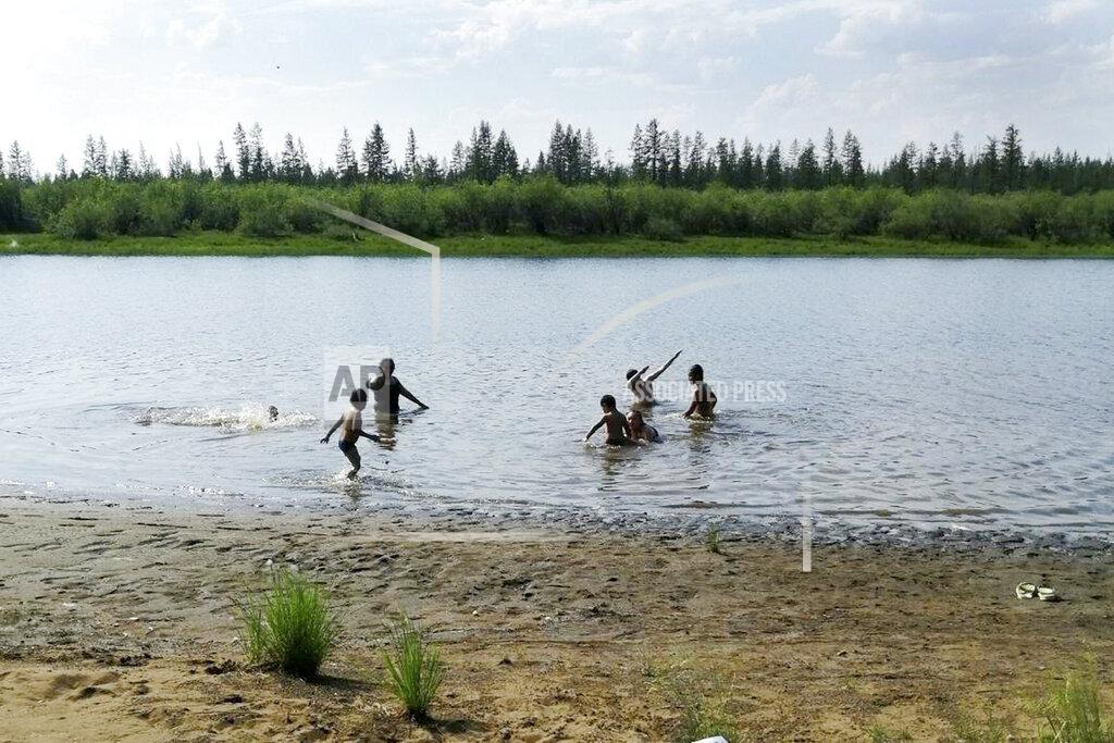 Olga Burtseva In this handout photo taken Sunday, June 21, 2020 and provided by Olga Burtseva, children play in the Krugloe lake outside Verkhoyansk, the Sakha Republic, about 4660 kilometers (2900 miles) northeast of Moscow, Russia. A record-breaking temperature of 38 degrees Celsius (100.4 degrees Fahrenheit) was registered in the Arctic town of Verkhoyansk on Saturday, June 20 in a prolonged heatwave that has alarmed scientists around the world. (Olga Burtseva via AP)