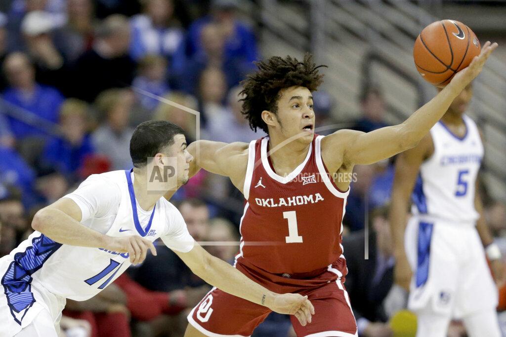 Nati Harnik Oklahoma's Jalen Hill (1) and Creighton's Marcus Zegarowski (11) go after a loose ball during the first half of an NCAA college basketball game in Omaha, Neb., Tuesday, Dec. 17, 2019. (AP Photo/Nati Harnik)