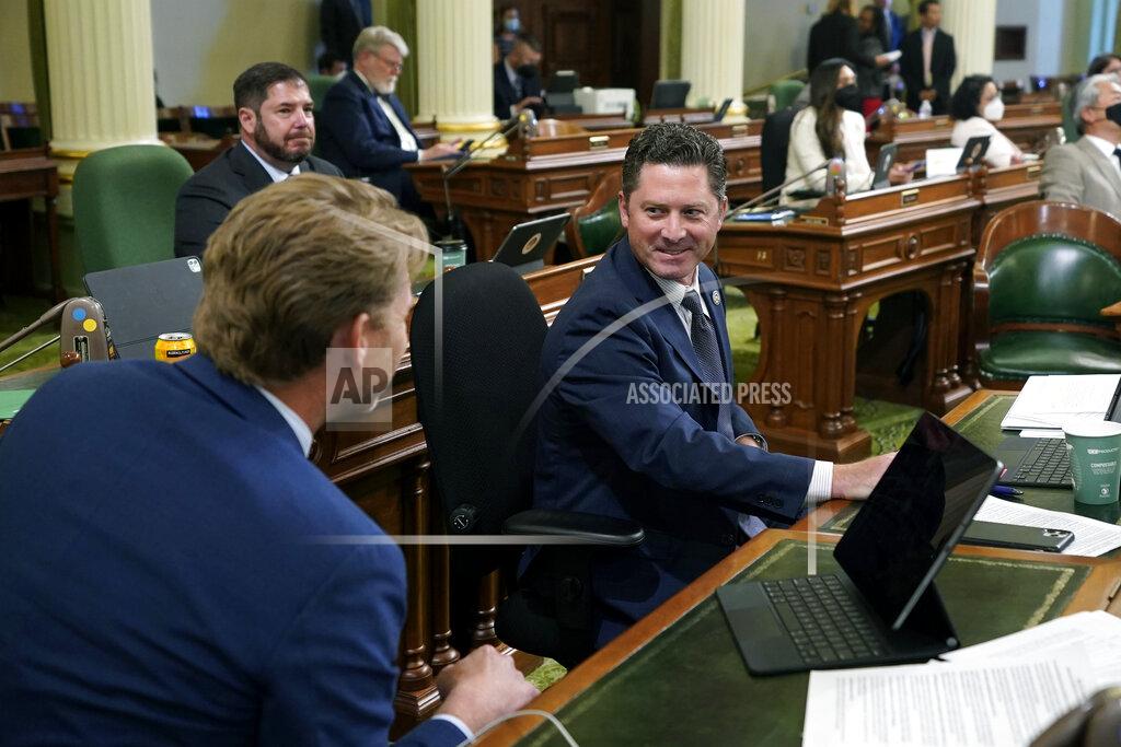 Rich Pedroncelli Assemblyman Jordon Cunningham, R-San Luis Obispo, right, smiles after his bill to hold social media companies responsible for harming children who have become addicted to their products was approved by the Assembly at the Capitol in Sacramento, Calif., on Monday, May 23, 2022. If approved by the Senate and signed by the governor, the bill would let parents sue platforms like Instagram and TikTok for up to $25,000 per violation. At left is Assemblyman Chad Mayes, I-Yucca Valley. (AP Photo/Rich Pedroncelli)