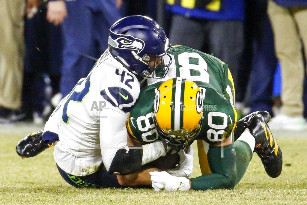 Matt Ludtke Green Bay Packers' Jimmy Graham catches a first down pass with Seattle Seahawks' Lano Hill defending during the second half of an NFL divisional playoff football game Sunday, Jan. 12, 2020, in Green Bay, Wis. The Packers won 28-23 to advance to the NFC Championship. (AP Photo/Matt Ludtke)