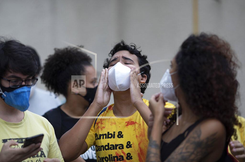 Silvia Izquierdo An activist shouts slogans during a protest the day after a deadly police operation in the Jacarezinho favela of Rio de Janeiro, Brazil, Friday, May 7, 2021. A bloody, hours-long gunbattle here echoed into Friday, with authorities saying the police mission killed two dozen criminals while residents and activists claimed human rights abuses. (AP Photo/Silvia Izquierdo)