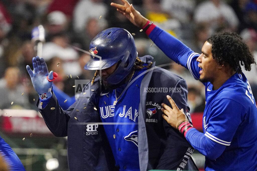Mark J. Terrill Toronto Blue Jays' Vladimir Guerrero Jr., left, is congratulated by Santiago Espinal as teammates throw sunflower seeds at him after he hit a solo home run during the sixth inning of a baseball game against the Los Angeles Angels Thursday, May 26, 2022, in Anaheim, Calif. (AP Photo/Mark J. Terrill)