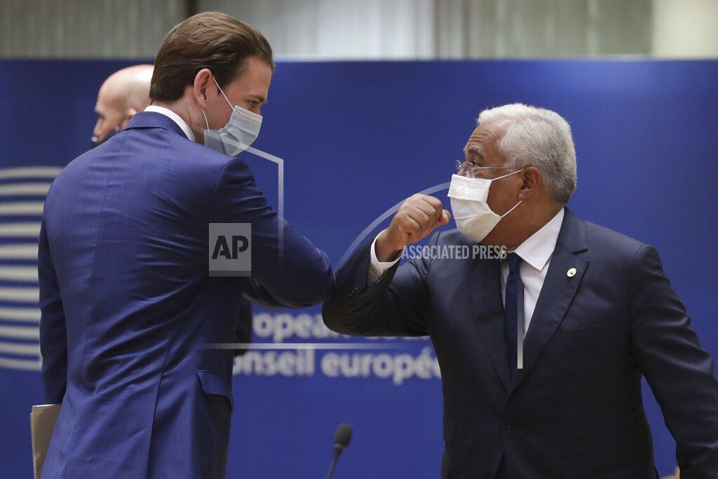 Stephanie Lecocq Austria's Chancellor Sebastian Kurz, left, greets Portugal's Prime Minister Antonio Costa, right, with an elbow bump during a round table meeting at an EU summit in Brussels, Friday, July 17, 2020. Leaders from 27 European Union nations meet face-to-face on Friday for the first time since February, despite the dangers of the coronavirus pandemic, to assess an overall budget and recovery package spread over seven years estimated at some 1.75 trillion to 1.85 trillion euros. (Stephanie Lecocq, Pool Photo via AP)