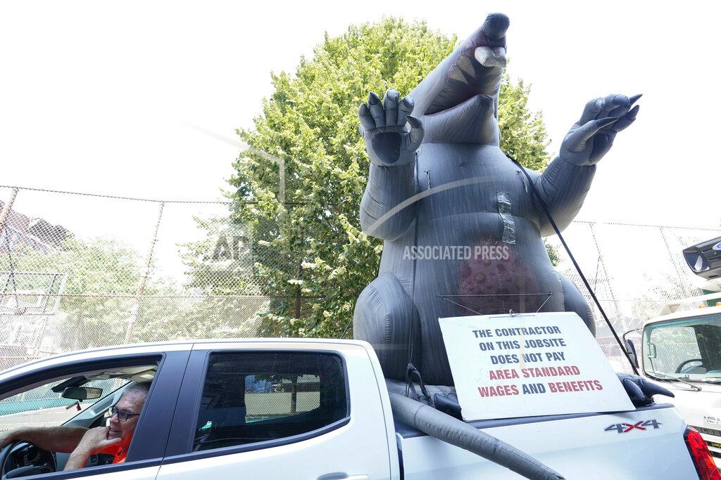 Mary Altaffer A member of the Carpenters' Union with an inflatable rat are protesting the contractor building a Shake Shack on the Lower East Side of Manhattan, Thursday, Aug. 4, 2022. On Friday, Aug. 5, the Labor Department delivers its July jobs report. (AP Photo/Mary Altaffer)