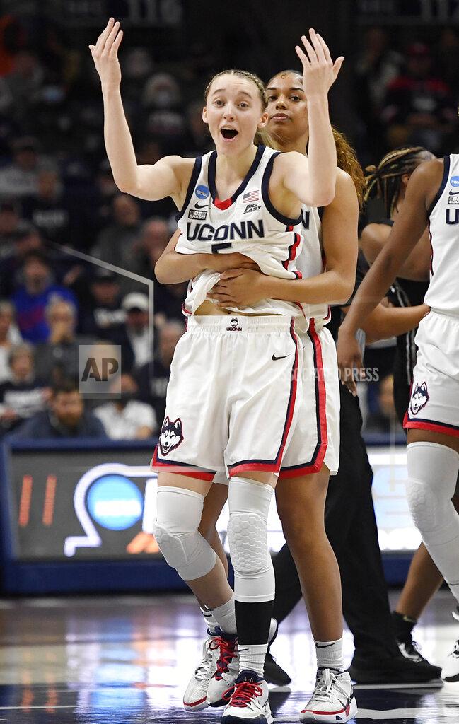 Jessica Hill Connecticut's Paige Bueckers, front, calls for support from fans as she is pulled away from a jump ball scrum by teammate Evina Westbrook during the first half of a second round women's college basketball game against Central Florida in the NCAA tournament, Monday, March 21, 2022, in Storrs, Conn. (AP Photo/Jessica Hill)