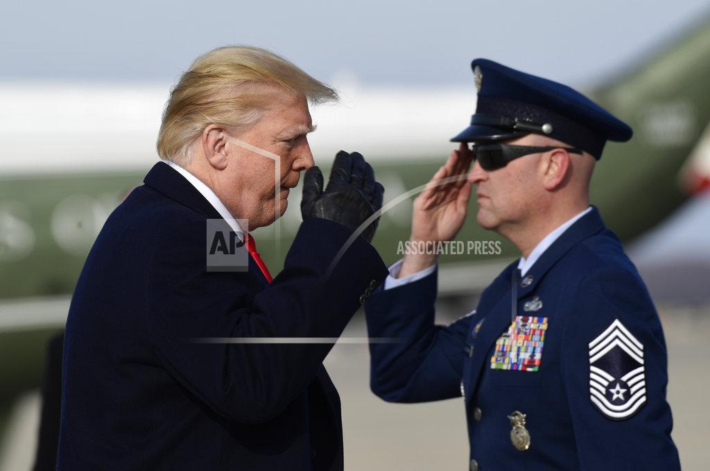 Susan Walsh President Donald Trump salutes as he walks up the steps of Air Force One at Andrews Air Force Base in Md., Saturday, Dec. 8, 2018. Trump is heading to the Army-Navy football game in Philadelphia. (AP Photo/Susan Walsh)