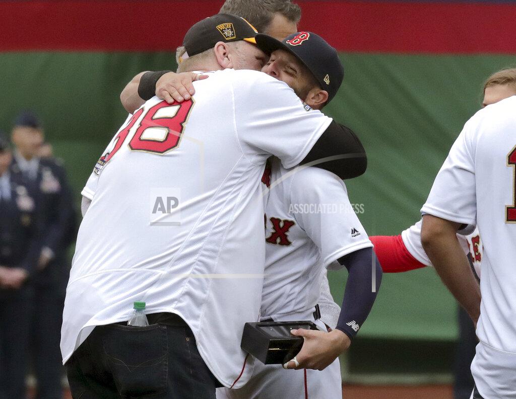 Charles Krupa Former Boston Red Sox pitcher Curt Schilling, left, hugs Dustin Pedroia during a ceremony before the home opener baseball game between the the Red Sox and Toronto Blue Jays, Tuesday, April 9, 2019, in Boston. (AP Photo/Charles Krupa)