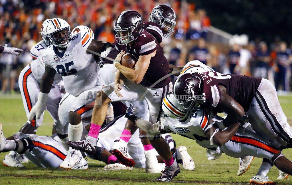 Rogelio V. Solis Mississippi State quarterback Nick Fitzgerald (7) runs past Auburn defenders for a 27-yard touchdown during the second half of their NCAA college football game in Starkville, Miss., Saturday, Oct. 6, 2018. Mississippi State won 23-9. (AP Photo/Rogelio V. Solis)