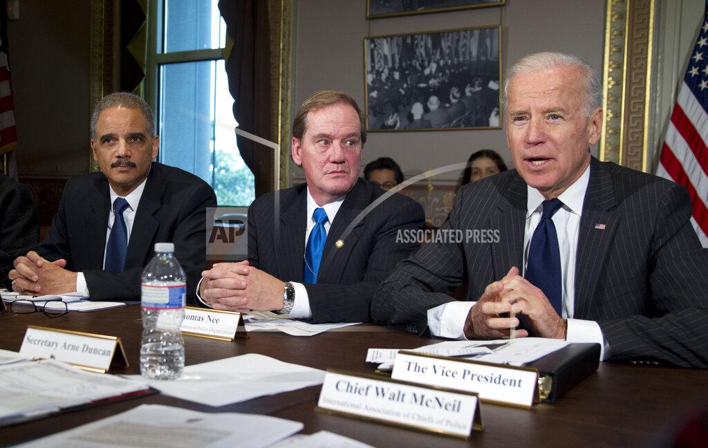 Carolyn Kaster FILE - Vice President Joe Biden, right, with President of the National Association of Police Organizations and Boston police officer, Thomas Nee, center and Attorney General Eric Holder, far left, speaks to media during a meeting at the Eisenhower Executive Office Building in the White House complex, Dec. 20, 2012, in Washington. Biden lead a task force that will look at ways of reducing gun violence. (AP Photo/Carolyn Kaster, File)