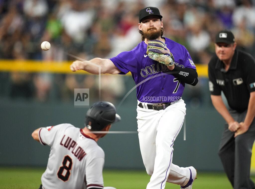 David Zalubowski Colorado Rockies second baseman Brendan Rodgers throws over Arizona Diamondbacks' Jordan Luplow after forcing him out at second base on the front end of a double play hit into by Cooper Hummel during the sixth inning of a baseball game Saturday, July 2, 2022, in Denver. (AP Photo/David Zalubowski)