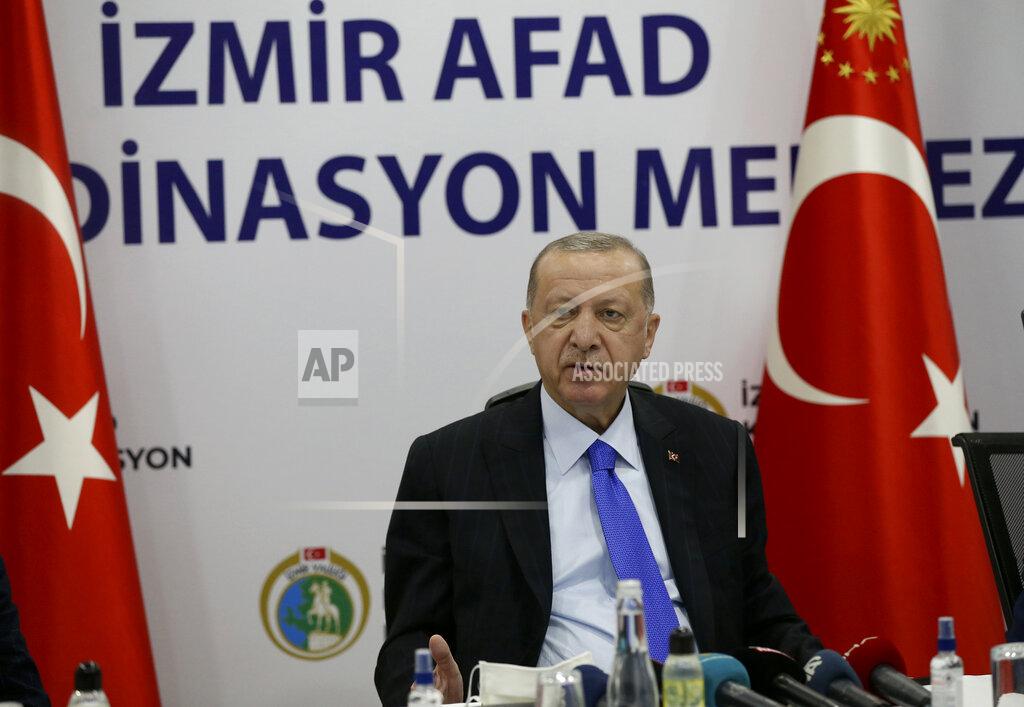 Uncredited Turkey's President Recep Tayyip Erdogan speaks at Izmir AFAD emergency response center, in Izmir, Turkey, Saturday, Oct. 31, 2020. Three young children and their mother were rescued alive from the rubble of a collapsed building in western Turkey on Saturday, some 23 hours after a powerful earthquake in the Aegean Sea killed several people and injured more than 800 others.(Turkish Presidency via AP, Pool)
