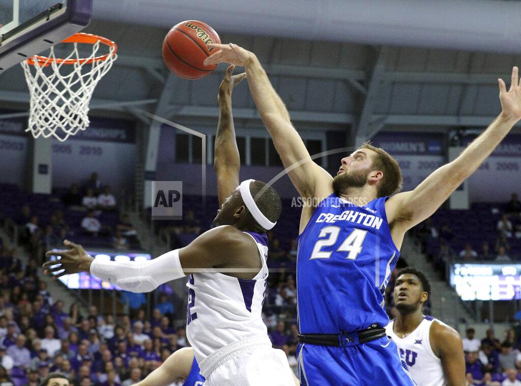 Richard W. Rodriguez TCU forward Kouat Noi (12) puts up a shot against Creighton guard Mitch Ballock (24) in the second half of an NCAA college basketball game in Fort Worth, Texas, Tuesday, March 26, 2019. TCU won, 71-58. (Richard W. Rodriguez/Star-Telegram via AP)
