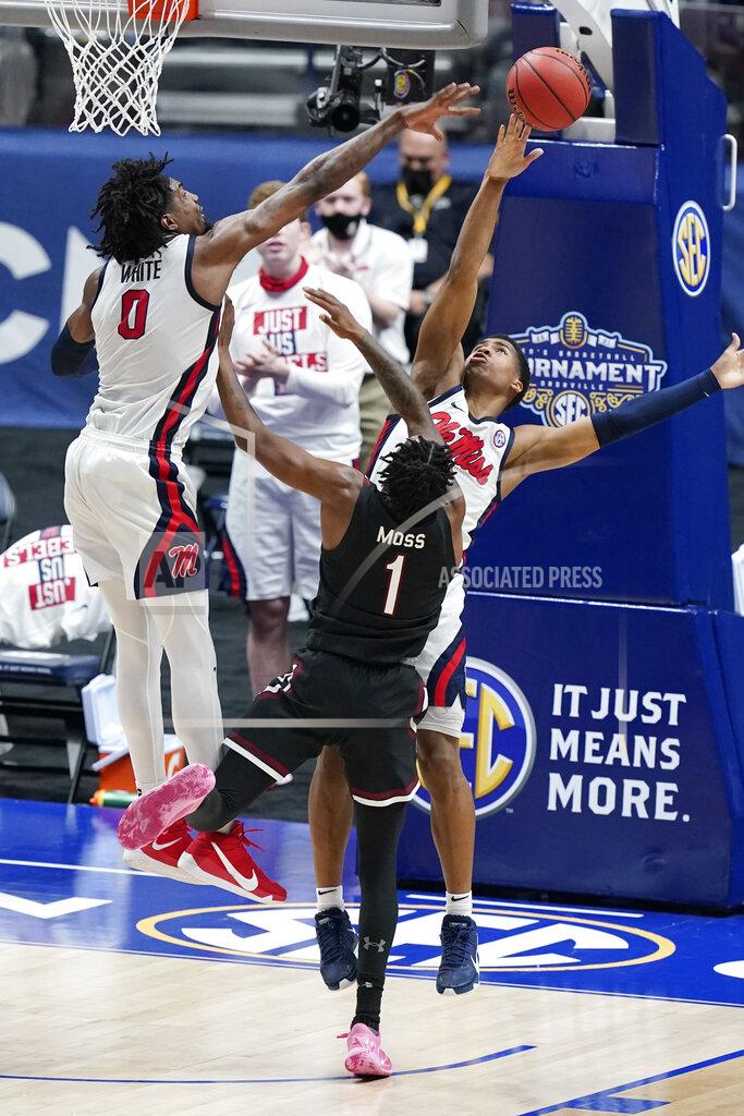 Mark Humphrey Mississippi's Romello White (0) and Matthew Murrell, right, block the path of South Carolina's T.J. Moss (1) in the first half of an NCAA college basketball game in the Southeastern Conference Tournament Thursday, March 11, 2021, in Nashville, Tenn. (AP Photo/Mark Humphrey)