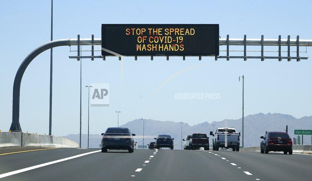 Ross D. Franklin The Arizona Department of Transportation posts new signage on along highways urging the public to wash hands due to the recent surge in coronavirus cases Sunday, June 21, 2020, in Phoenix. (AP Photo/Ross D. Franklin)