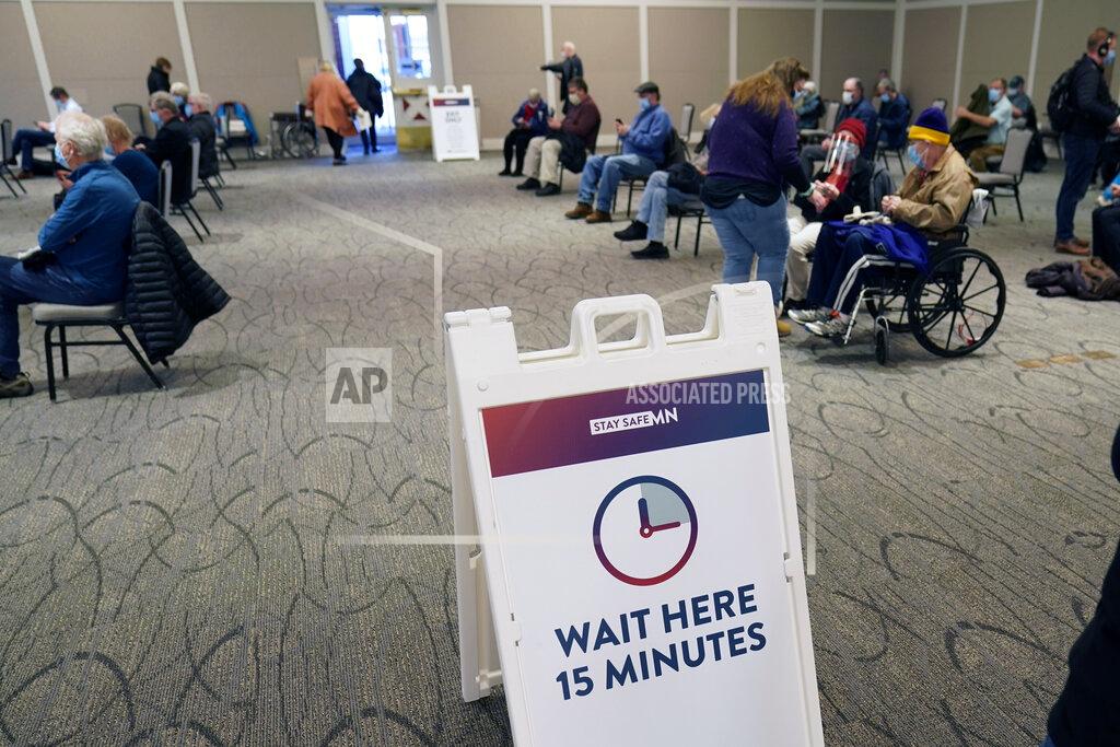 Jim Mone People who received a vaccination, Thursday, Jan. 21, 2021 at the Earle Brown Heritage Center in Brooklyn Center, Minn., wait the 15 minutes before leaving. Minnesota on Thursday opened up nine locations for coronavirus vaccinations as part of a pilot program reserved for people 65 and over. Demand for the program was exceptionally heavy, with slots for the few available doses quickly filling after registration opened two days earlier. (AP Photo/Jim Mone)