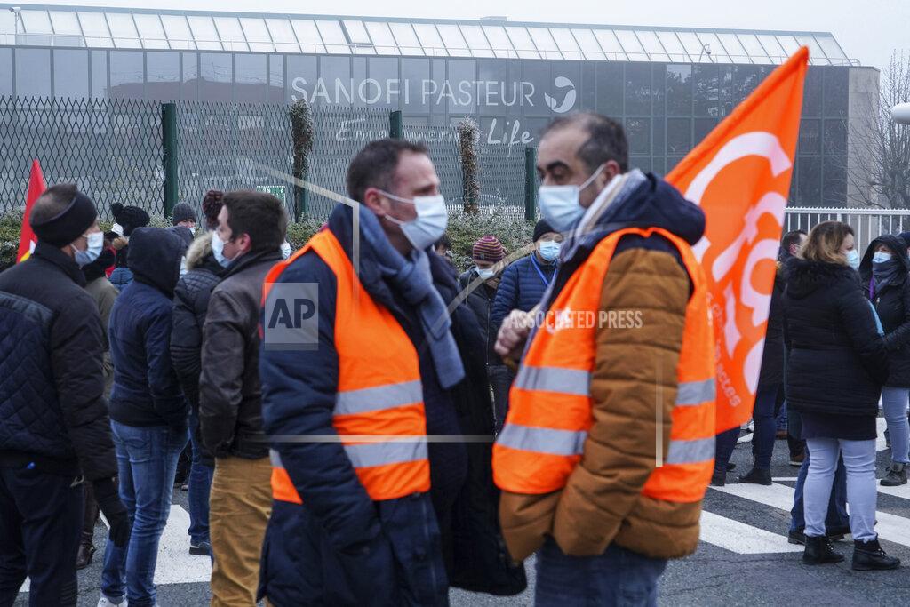Laurent Cipriani Striking workers gather outside the French pharmaceutical company Sanofi headquarters in Marcy l'Etoile, central France, Tuesday, Jan.19, 2021. Employees of pharmaceutical company Sanofi stage a protest against planned redundancies that they say could slow the fight against the Coronavirus pandemic . Sanofi had been developing Covid vaccines but will not be ready to roll out until late 2021. (AP Photo/Laurent Cipriani)