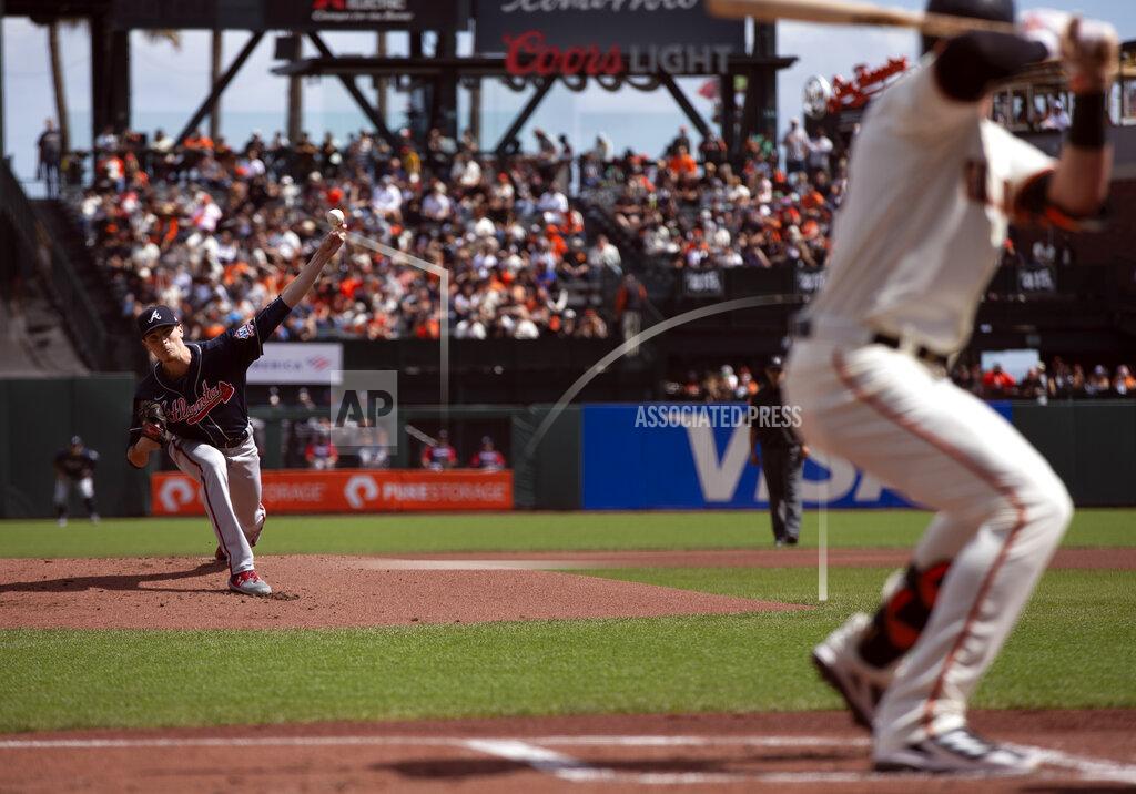 D. Ross Cameron Atlanta Braves starting pitcher Max Fried, left, delivers to San Francisco Giants' Kris Bryant, right, during the first inning of a baseball game, Sunday, Sept. 19, 2021, in San Francisco. (AP Photo/D. Ross Cameron)