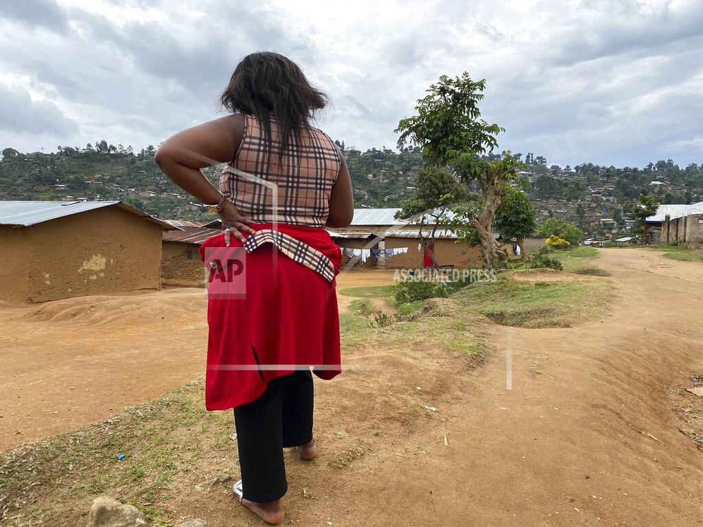 Kudra Maliro Shekinah stands near her home in Beni, eastern Congo on Thursday, March 18, 2021. When she was working as a nurse’s aide in northeastern Congo in January 2019, she said World Health Organization Dr. Boubacar Diallo, of Canada, offered her a job investigating Ebola cases at double her previous salary _ with a catch. "When he asked me to sleep with him, given the financial difficulties of my family….I accepted.” (AP Photo/Kudra Maliro)