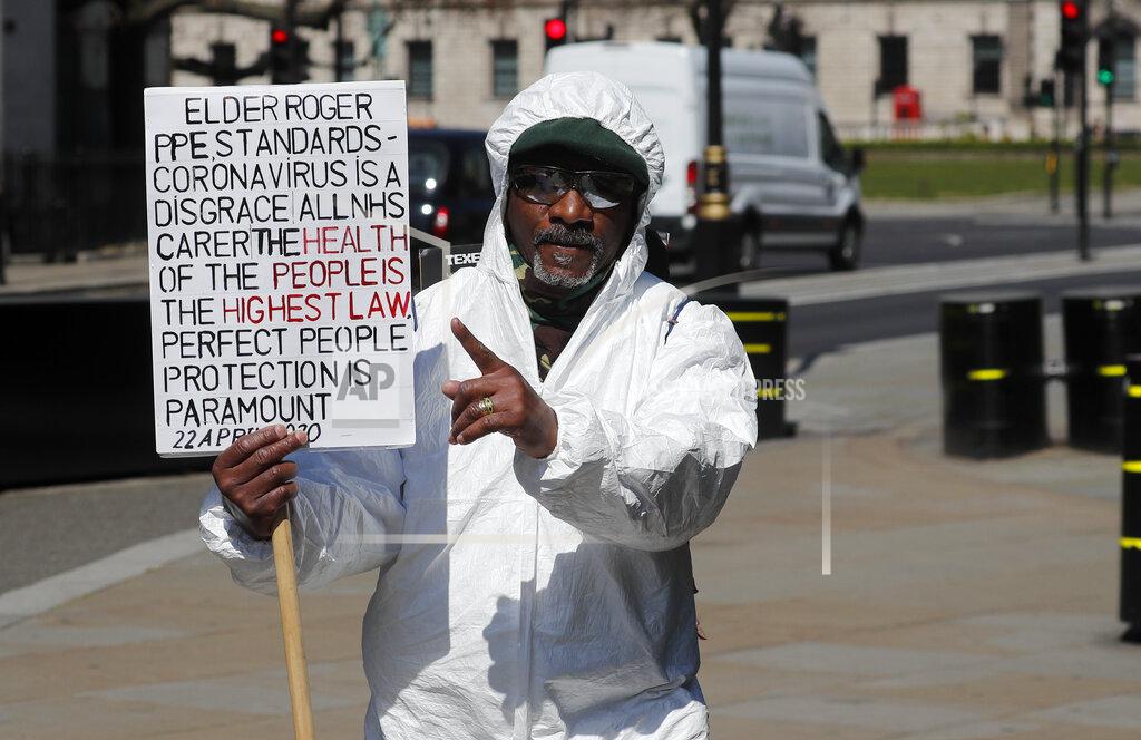Frank Augstein A protestor walks alongside Parliament demanding more PPE for healthcare workers, in central London, Wednesday April 22, 2020 during the COVID-19 lockdown. (AP Photo/Frank Augstein)