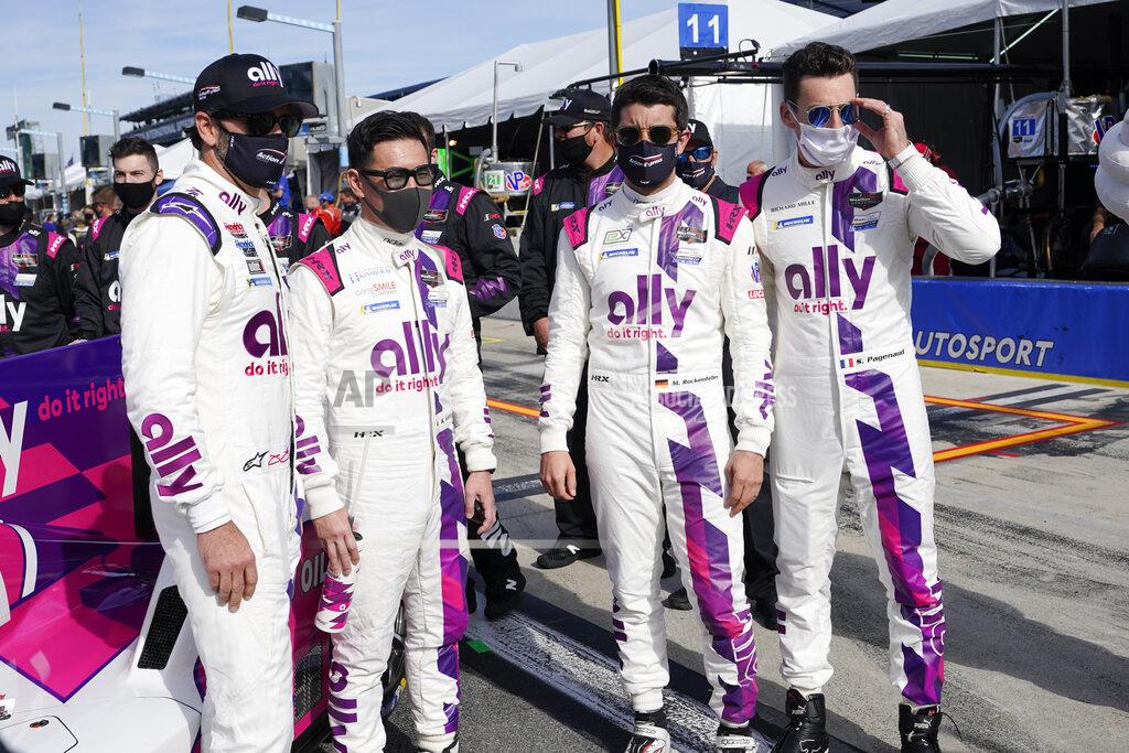 John Raoux IMSA Series driving team from left, Jimmie Johnson, Kamui Kobayashi, Mike Rockenfeller and Simon Pagenaud gather for a photo before the start of the Rolex 24 hour auto race at Daytona International Speedway, Saturday, Jan. 30, 2021, in Daytona Beach, Fla. (AP Photo/John Raoux)