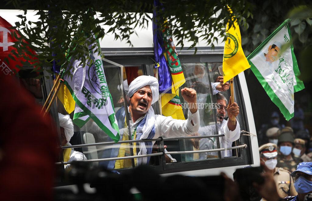 Manish Swarup Indian farmers arrive at a protest site to hold mock farmer's parliament in New Delhi, India, Thursday, July 22, 2021. More than 200 farmers on Thursday began a protest near India's Parliament to mark eight months of their agitation against new agricultural laws that they say will devastate their income. (AP Photo/Manish Swarup)