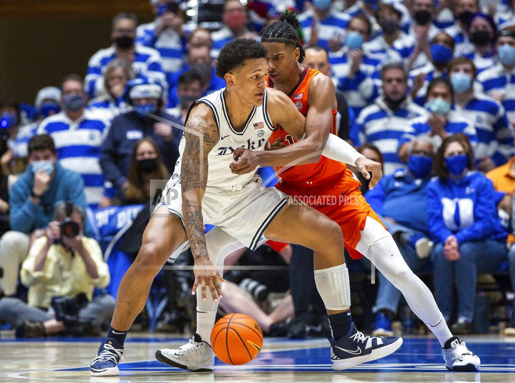 Ben Mckeown Duke's Paolo Banchero, left, handles the ball while Virginia Tech's David N'Guessan, right, defends during the first half of an NCAA college basketball game in Durham, N.C., Wednesday, Dec. 22, 2021. (AP Photo/Ben McKeown)