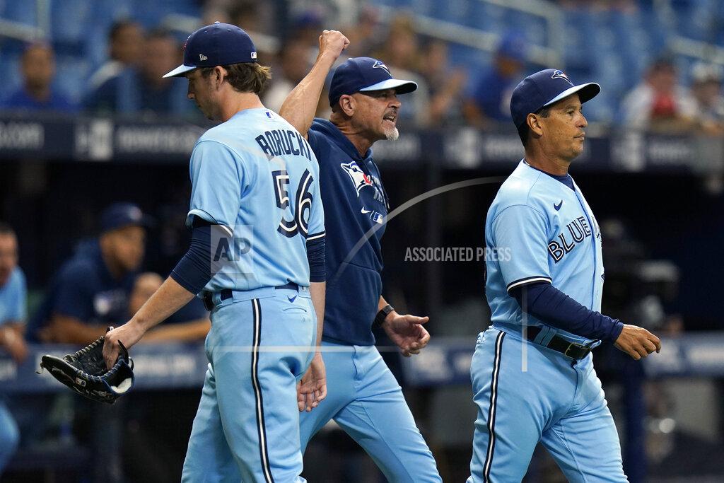Chris O'MEara Toronto Blue Jays manager Charlie Montoyo, right, and pitching coach Pete Walker, center, run onto the field after starting pitcher Ryan Borucki, left, was ejected after hitting Tampa Bay Rays' Kevin Kiermaier with a pitch during the eighth inning of a baseball game Wednesday, Sept. 22, 2021, in St. Petersburg, Fla. (AP Photo/Chris O'Meara)