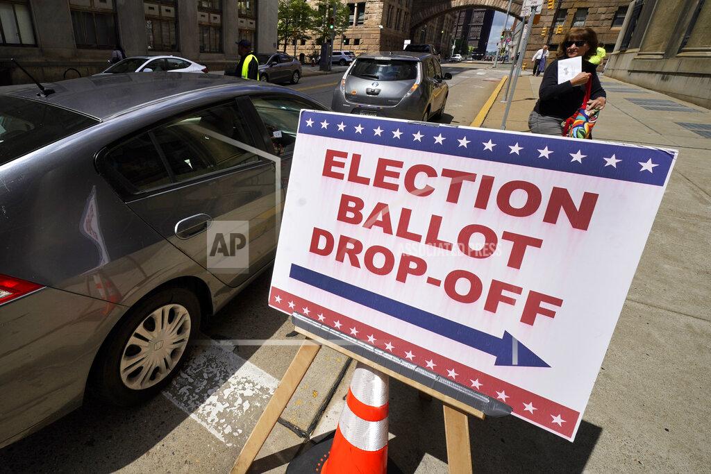Gene J. Puskar A voter arrives to cast their mail-in ballot at the City-County Building in downtown Pittsburgh Monday, May 16, 2022. (AP Photo/Gene J. Puskar)