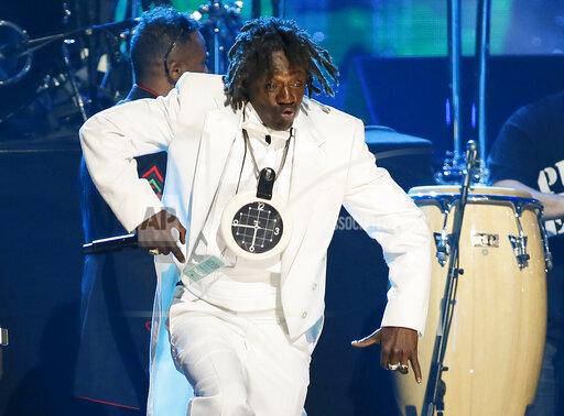 FILE - Flavor Flav of Public Enemy performs during the band's induction at the Rock and Roll Hall of Fame Induction Ceremony at the Nokia Theatre in Los Angeles on April 18, 2013. Attorneys for entertainer Flavor Flav said Wednesday, Dec. 8, 2021, he's working to stay sober following the dismissal of a misdemeanor domestic violence charge stemming from a scuffle with his girlfriend at home in suburban Las Vegas. (Photo by Danny Moloshok/Invision/AP, File)