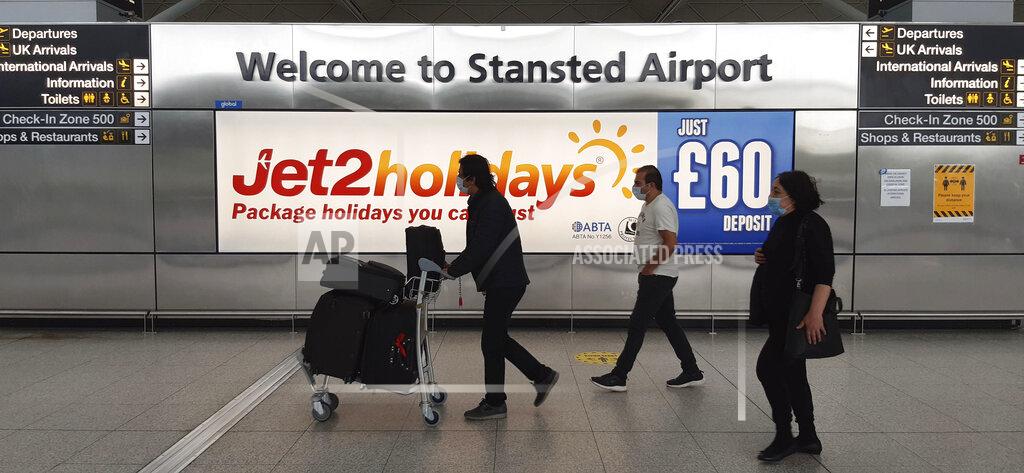 Nick Ansell People at Stansted Airport, north of London, Wednesday June 3, 2020, as new quarantine rules for travellers arriving in the UK are to be set out by Home Secretary Priti Patel. The plans, due to come into force on June 8, will see people arriving in the UK told to isolate for 14-days to prevent coronavirus cases being introduced from overseas. (Nick Ansell/PA via AP)